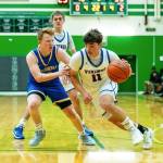 PHOTO BY MATT RUMBLES Willapa Valleys Lucas Lusk (11) drives against Columbia Adventists Carter Krenzler during the Vikings 63-60 loss in a 1B State Tournament game on Saturday at Tumwater High School.
