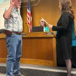 Jerry Knaak / The Daily World
New Ocean City Drainage District Commissioner Stan Sturgeon takes his oath of office administered by Grays Harbor County Commissioner Vickie Raines.