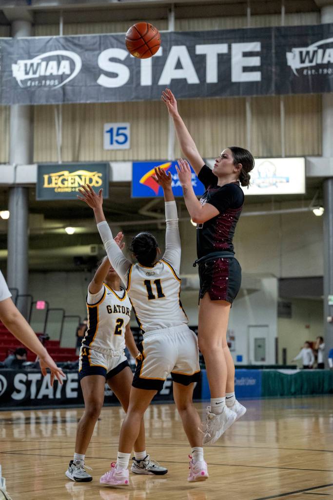 PHOTO BY FOREST WORGUM Montesanos Jillie Dalan (right) shoots over Annie Wrights Aaliyeh Martin (11) during a 47-33 loss in a 1A State Tournament Round of 12 game on Wednesday at the SunDome in Yakima.