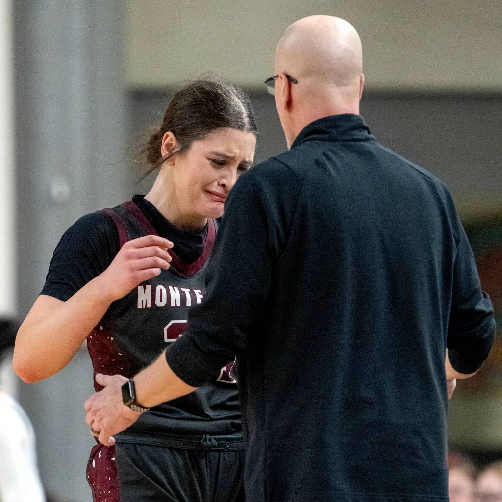 PHOTO BY FOREST WORGUM Montesano senior Jillie Dalan (left) is consoled by head coach Mark Mansfield after fouling out late in the fourth quarter of a 47-33 loss to Annie Wright in a 1A State Tournament Round of 12 game on Wednesday at the SunDome in Yakima.