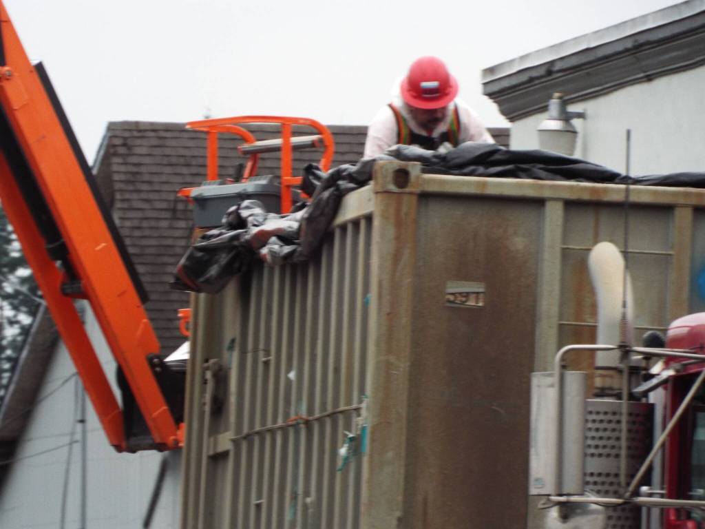 Because of the asbestos-containing materials within the theater, the containers were lined before being filled with debris and then sealed before the truck departed.