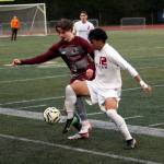 RYAN SPARKS | THE DAILY WORLD Montesanos Andrew Bruland (left) and Hoquiams J.B. Fabian battle for possession during the Bulldogs 6-4 season-opening win on Thursday at Montesano High School.