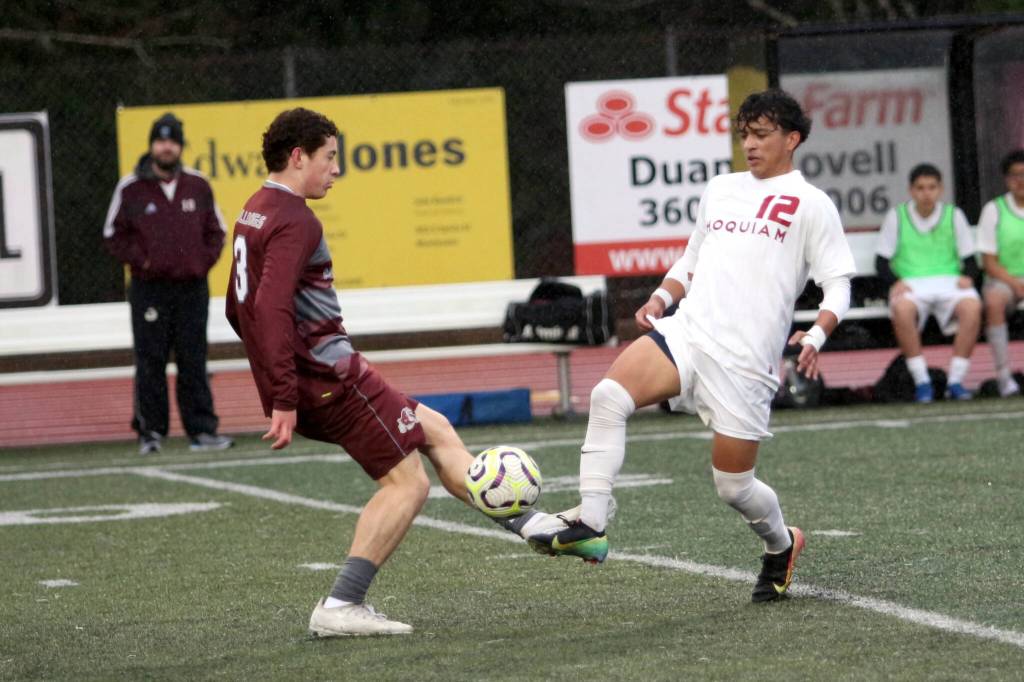 RYAN SPARKS | THE DAILY WORLD Montesanos Terek Gunter (left) and Hoquiams J.B. Fabian meet at the ball during the Bulldogs 6-4 season-opening win on Thursday in Montesano.