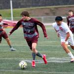 RYAN SPARKS | THE DAILY WORLD Montesanos Peter Bruland (7) races away from Hoquiams Dylan Avila-Guzman during the Bulldogs 6-4 season-opening win on Thursday at Jack Rottle Field in Montesano.