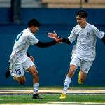 PHOTO BY FOREST WORGUM Elmas Manny Venegas (left) gets a high-five from teammate Bryan Torres after scoring a goal during a 3-1 loss to Aberdeen on Thursday in Aberdeen.