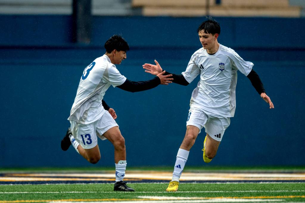 PHOTO BY FOREST WORGUM Elmas Manny Venegas (left) gets a high-five from teammate Bryan Torres after scoring a goal during a 3-1 loss to Aberdeen on Thursday in Aberdeen.