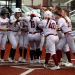 RYAN SPARKS | THE DAILY WORLD Montesano shortstop Jaelyn Butterfield (13) is met by her teammates after hitting a home run in the Bulldogs 11-0 win over Tenino on Monday at Montesano High School.