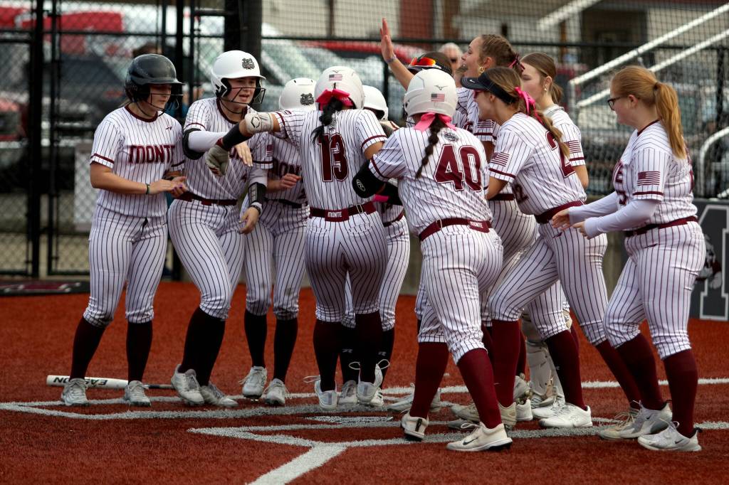 RYAN SPARKS | THE DAILY WORLD Montesano shortstop Jaelyn Butterfield (13) is met by her teammates after hitting a home run in the Bulldogs 11-0 win over Tenino on Monday at Montesano High School.