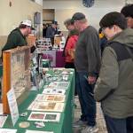 Jerry Knaak / The Daily World
Festivalgoers visit the Washington Department of Fish and Wildlife table.