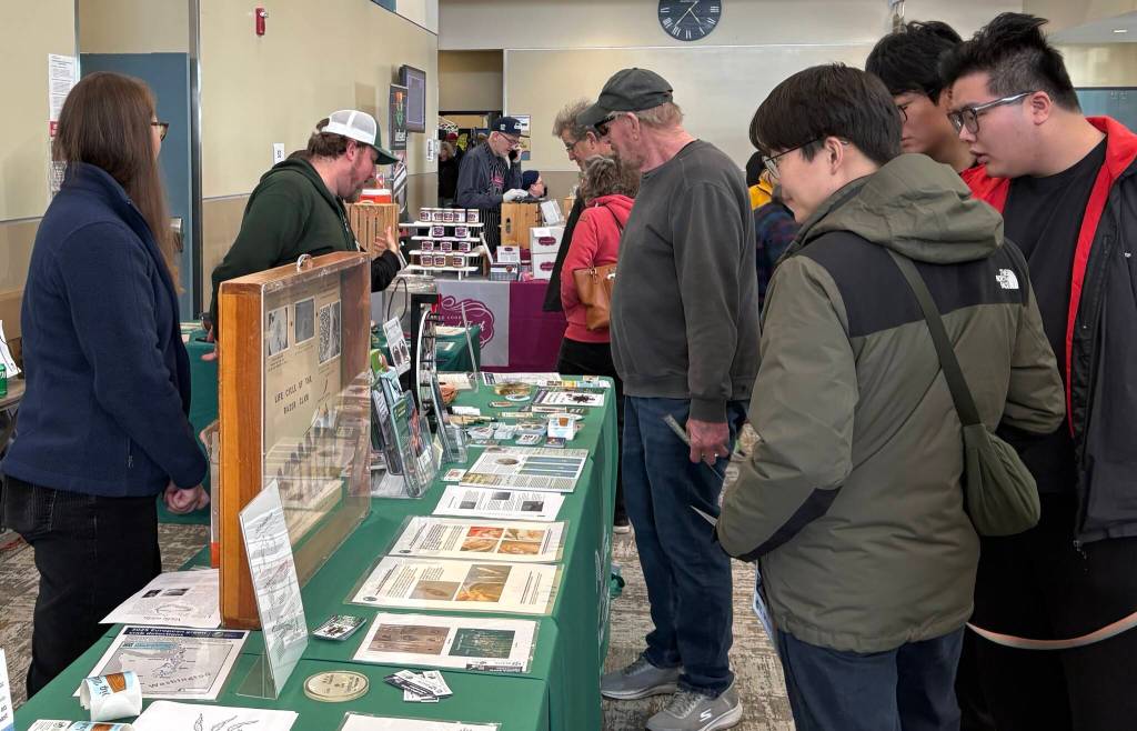 Jerry Knaak / The Daily World
Festivalgoers visit the Washington Department of Fish and Wildlife table.