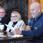 Aberdeen Mayor Douglas Orr reads remarks at the Greater Grays Harbor, Inc. Lunch with the Mayors while Oakville Mayor Bill Breedlove and Cosmopolis Mayor Linda Springer look on.