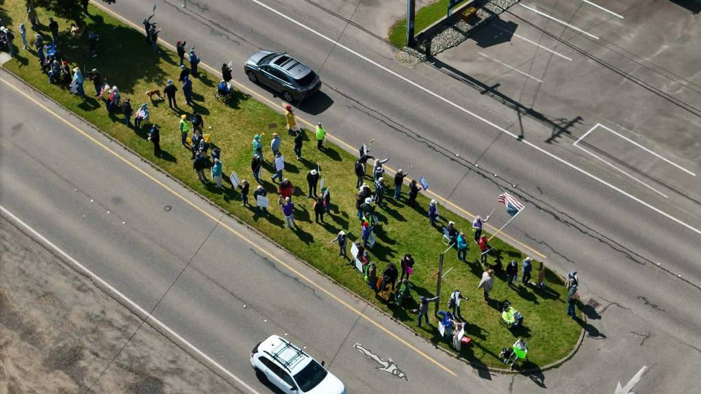 Rallygoers occupy the median on Point Brown Avenue in Ocean Shores during Saturday's "No Kings" protest. (CJ Ripley)