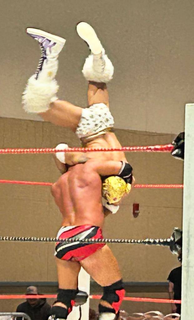 Christopher Ryseck prepares to slam El Tigre Oro during their match Saturday for Rogue Wrestlings Equinox Eruptions at the Ocean Shores Convention Center.