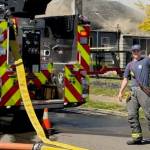 Aberdeen Fireman Brandon Rayner signals thumbs up to other firemen attaching hoses to fire hydrants Thursday.