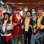The Putt Pirates pose for a team photo at the Ace of Clubs Tavern in Hoquiam before moving on to their next hole during the Putt Putt Pub Crawl Sunday.
