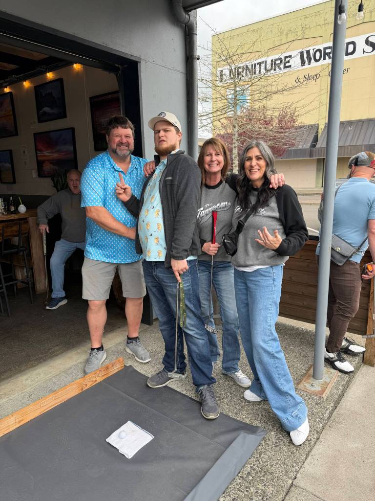 Mini-golfers practice putting at the Mount Olympus Brewing Co. hole Sunday during the Putt Putt Pub Crawl. From left: Larry Gladsjo, Riley Monteith, Teresa Gladsjo and Tonya Wood.
