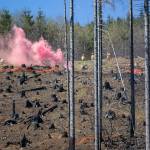Inserted personnel set off colored smoke to indicate the drop point during the DNR aviation exercise in the Capitol State Forest in April of 2024.