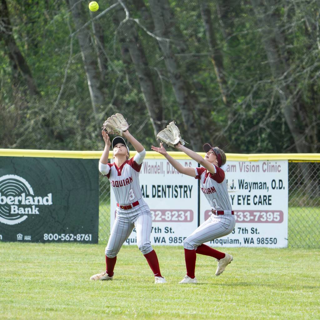 NICOLE SHANNON | MAIN FOCUS MEDIA Hoquiam outfielders Hailee Burgess (left) and Avery Brodhead track a fly ball during a 6-0 loss to Elma on Thursday in Hoquiam.