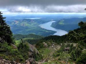 Photo by Alex Brown/Stateline
Clouds hang over Lake Cushman, as seen from the mountains of the Olympic National Forest. The U.S. Forest Service has announced plans to close 57 research stations in 31 states.