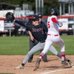 PHOTO BY FOREST WORGUM Montesano first baseman Kole Kjesbu (left) stretches to record a put out during a 19-0 win over Tenino on Friday in Tenino.