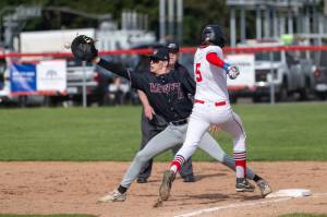 PHOTO BY FOREST WORGUM Montesano first baseman Kole Kjesbu (left) stretches to record a put out during a 19-0 win over Tenino on Friday in Tenino.