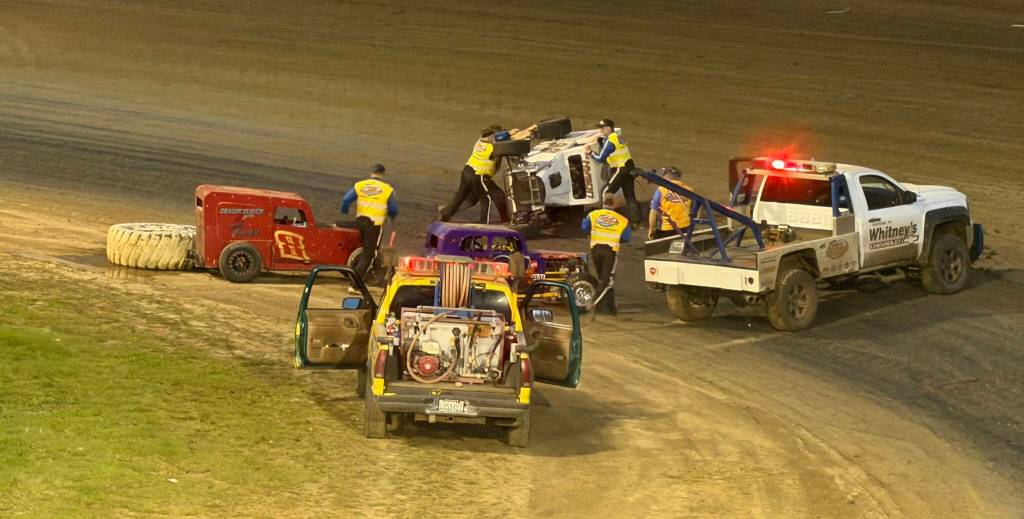 The Daily World
Emergency crews race to aid #92 Steve Hyson after a rollover in turn one of the PHRA Dwarf Car final Saturday night in Elma. Hyson was not injured in the accident, but did not finish the race.