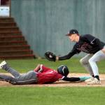 RYAN SPARKS | THE DAILY WORLD Hoquiams Moses DeShazer (left) slides back to first base ahead of the tag of Montesanos Kole Kjesbu during the second game of a doubleheader on Monday at Olympic Stadium in Hoquiam.