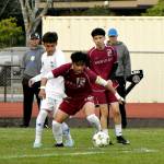 PHOTO BY CINDY MILES Hoquiams J.B. Fabian (12) and Elmas Ivan Rodriguez compete for possession during the Eagles 6-2 win on Monday at the Sea Breeze Oval in Hoquiam.