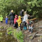 WDFW
Parents and children dressed in colorful rain gear enjoy opening day at Deep Lake in Thurston County.