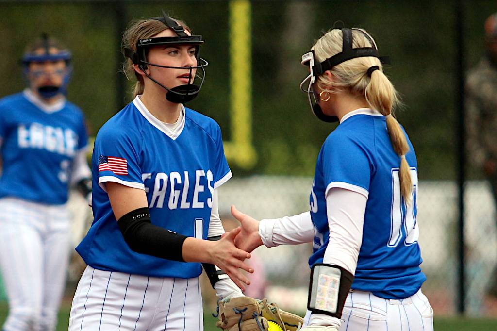 RYAN SPARKS | THE DAILY WORLD Elma pitcher Ashlynn Weld (left) and third baseman Lynsee Bednarik give each other five during a 10-6 loss to Montesano on Thursday at Montesano High School.