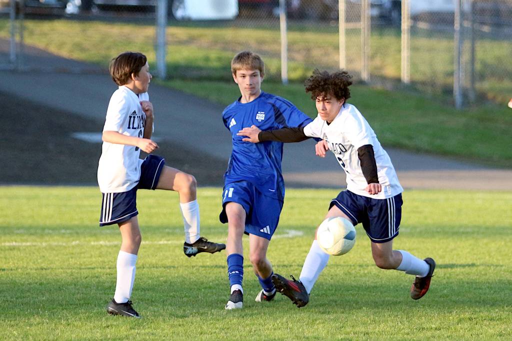 RYAN SPARKS | THE DAILY WORLD Elmas Isaiah Vargo (middle) sends the ball forward during a 12-0 victory over Ilwaco on Friday at Davis Field in Elma.