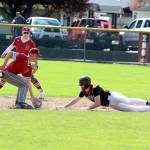 RYAN SPARKS | THE DAILY WORLD Montesanos Caden Grubb (right) slides in ahead of the tag by Hoquiams Talan Abbott during the Bulldogs 5-3 win on Friday in Montesano.