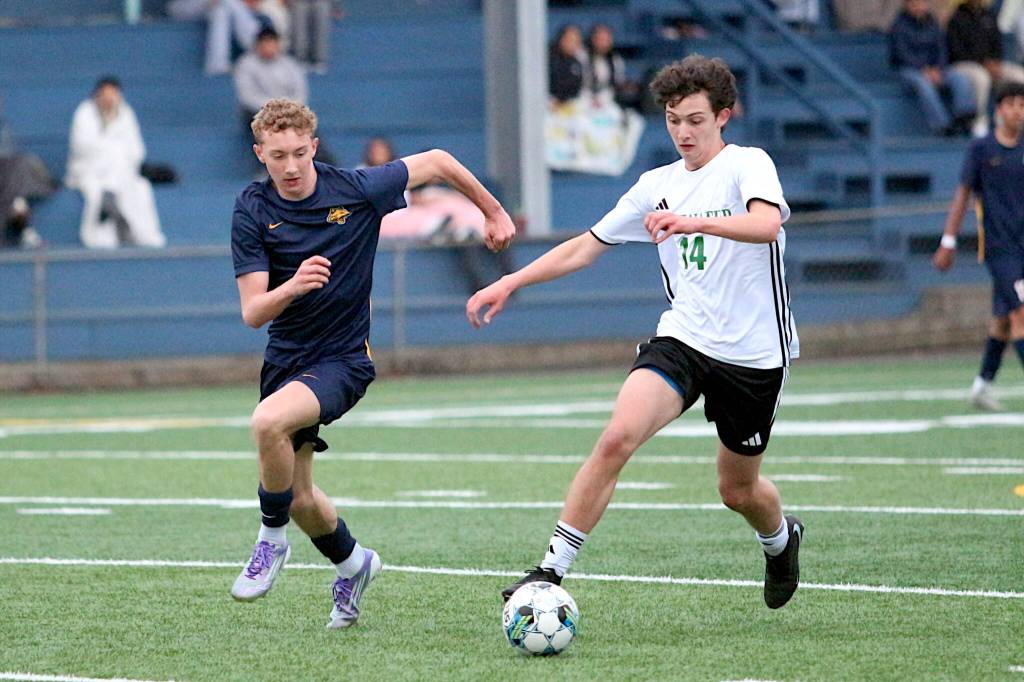 RYAN SPARKS | THE DAILY WORLD Aberdeens Tyson Dunlap (left) and Tumwaters Colin Holien pursue the ball in the Bobcats 2-1 victory (5-4 on penalty kicks) in a 2A Evergreen Conference game on Friday at Stewart Field in Aberdeen.