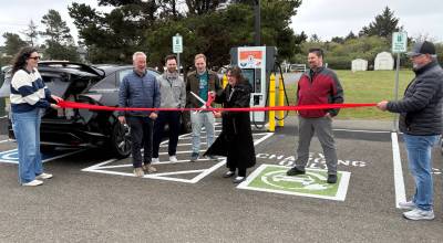 Jerry Knaak / The Daily World
Ocean Shores Public Library Director Keitha Owen cuts the ribbon officially opening the new EVCS charging station.