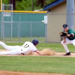 RYAN SPARKS | THE DAILY WORLD Aberdeens Mylan Bruner (left) slides in safely to first base during a 5-1 win over Woodland in a 2A District 4 play-in game on Friday at Pioneer Park in Aberdeen.