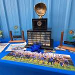 RYAN SPARKS | THE DAILY WORLD A display at a ceremony honoring former Elma softball coach Mitchell Todd, who passed away on May 3 in a vehicle accident, exhibits the 1A State Championship trophy, of which Elma won with the help of Todd in 2014.