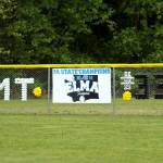 RYAN SPARKS | THE DAILY WORLD The centerfield fence at the Legacy Softball Field in Elma is adorned with the initials of former softball coach Mitchell Todd, who died in a traffic accident on May 3 and was honored before the Elma-Cedar Park Christian softball game on Friday.