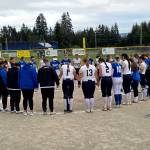 RYAN SPARKS | THE DAILY WORLD Players from Elma (blue) and Cedar Park Christian say a prayer for Mitchell Todd and his family after a game on Friday in Elma.