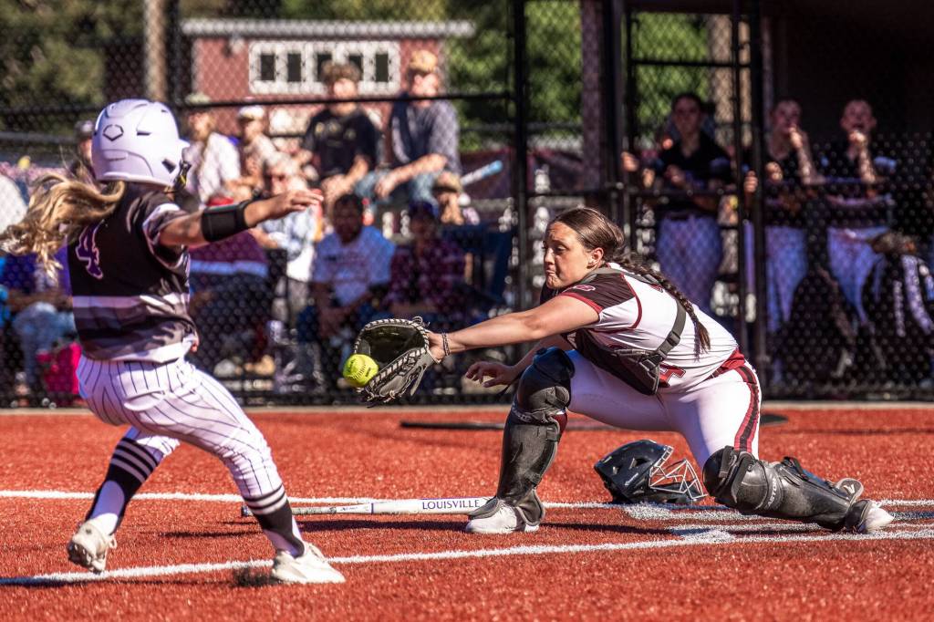 MATT RUMBLES PHOTOGRAPHY Raymond-South Bend catcher Ava Pine (right) records an out during a 5-3 win over Onalaska in a 2B District 4 Tournament game on Monday at Dick Tagman Field in Montesano.