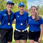 SUBMITTED PHOTO Elmas Mercedes Carter (left), Olivia Moore and Kyla Rudy (right) pose for a photo at the conclusion of the 1A District 4 Championships on Monday at the Tumwater Valley Golf Course.