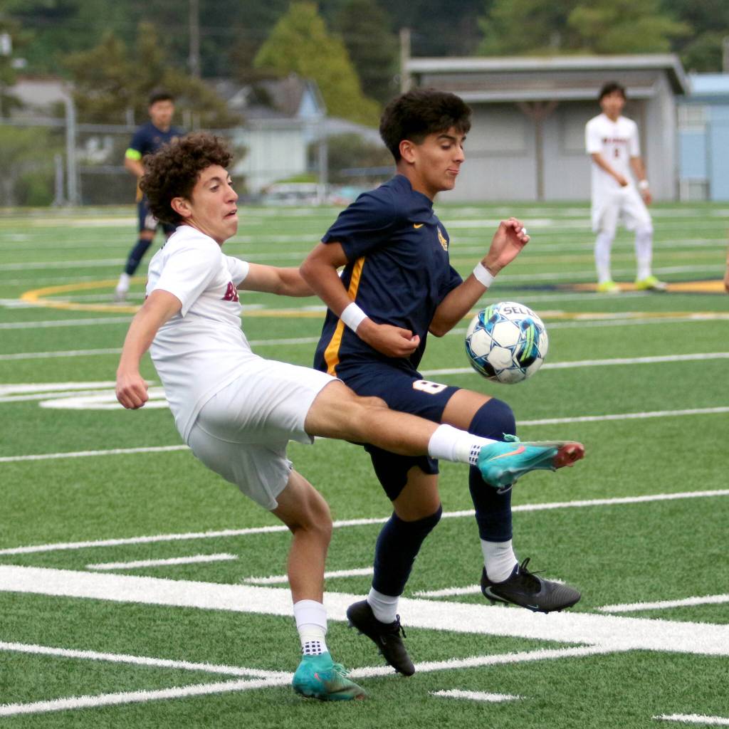 RYAN SPARKS | THE DAILY WORLD Aberdeen midfielder Gibran Garcia (right) pries the ball away from a W.F. West player during the Bobcats 4-0 win in a 2A District 4 elimination game on Tuesday at Stewart Field in Aberdeen.