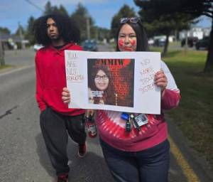Chelsea Capoeman photos
Marchers hold up signs as they make their way through the main drag in Ocean Shores.