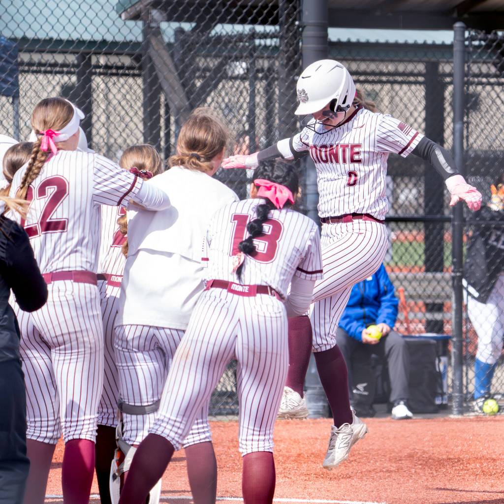 NICOLE SHANNON | MAIN FOCUS MEDIA Montesano catcher Addi Williamsen jumps on to home plate after hitting one of four Bulldogs home runs in a 14-0 win over Elma in the 1A District championship game on Saturday in Centralia.