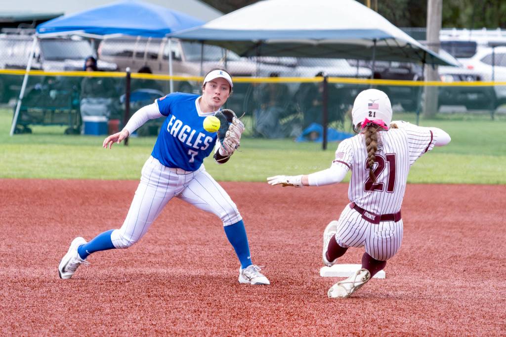 NICOLE SHANNON | MAIN FOCUS MEDIA Elma shortstop Aubree Simmons (left) receives a throw while Montesanos Ashlyn Lytle races to second base in the Bulldogs 14-0 win in the 1A District championship game on Saturday in Centralia.