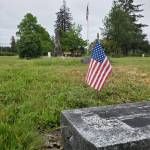 Andrea Watts / The Daily World
At the Odd Fellows Cemetery in Elma, American flags are placed by the headstones of veterans in preparation for Memorial Day, May 25.