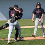 PHOTO BY FOREST WORGUM Montesano pitcher Caden Grubb (17) hugs brother Colton Grubb while teammate Kolson Hendrickson celebrates after the Bulldogs defeated Charles Wright/Life Christian Academy 3-0 in a 1A State quarterfinal game on Saturday in Hoquiam.