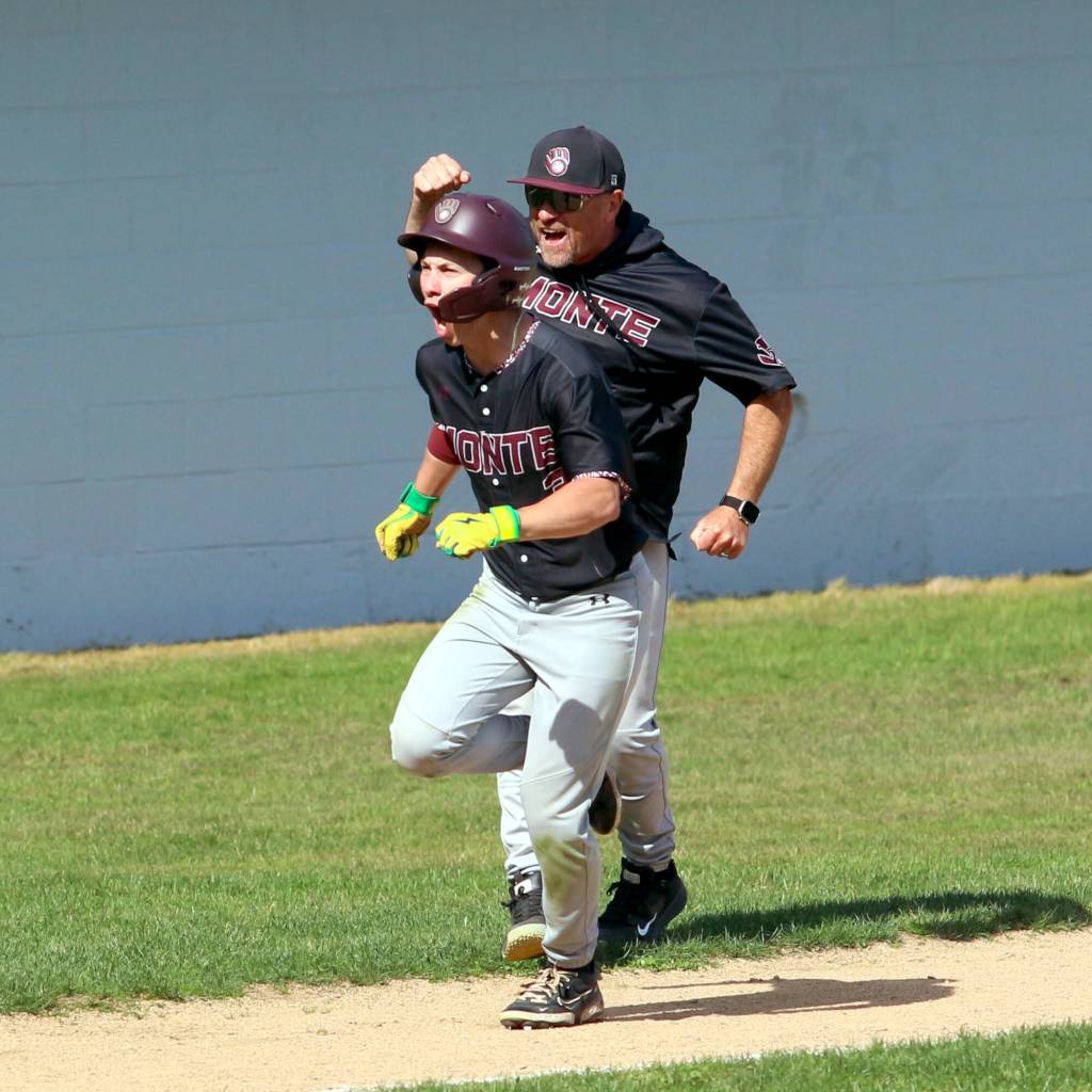 RYAN SPARKS | THE DAILY WORLD Montesano senior Carter Ames (left) rounds third as head coach Mike Osgood cheers him on after hitting a home run in the sixth inning of a 3-0 win over Charles Wright-Life Christian Academy in a 1A State semifinal game on Saturday in Hoquiam.
RYAN SPARKS | THE DAILY WORLD Montesano senior Carter Ames (left) rounds third as head coach Mike Osgood cheers him on after hitting a home run in the sixth inning of a 3-0 win over Charles Wright-Life Christian Academy in a 1A State semifinal game on Saturday in Hoquiam.