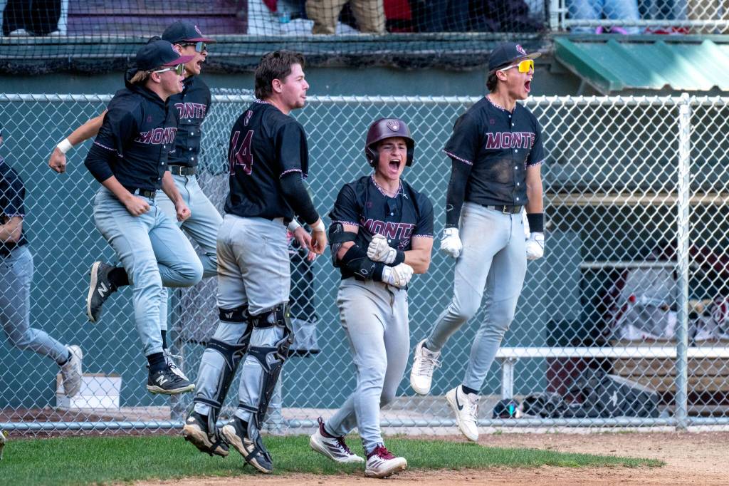 PHOTO BY FOREST WORGUM Montesano players celebrate a home run by teammate Carter Ames during a 3-0 win over Charles Wright-Life Christian Academy in a 1A State semifinal game on Saturday in Hoquiam.