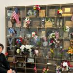 Submitted photo
Johnathan Bullard, an Aberdeen High School student who sang the National Anthem, sits next to the decorated memorial cabinet in the mausoleum at Fern Hill Cemetery on Monday.