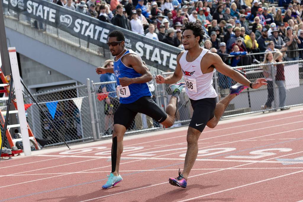 PHOTO BY MIKE ROBERTS Elmas Ritchie Guadarrama (left) races with Kings Jeshua Singletary during a boys 200-meter race at the WIAA 1A State Championships on Saturday at Eisenhower High School in Yakima.